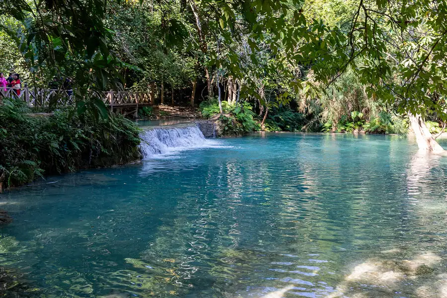 Turquoise lower swimming pool below the Kuang Si waterfalls in Luang Prabang, Laos