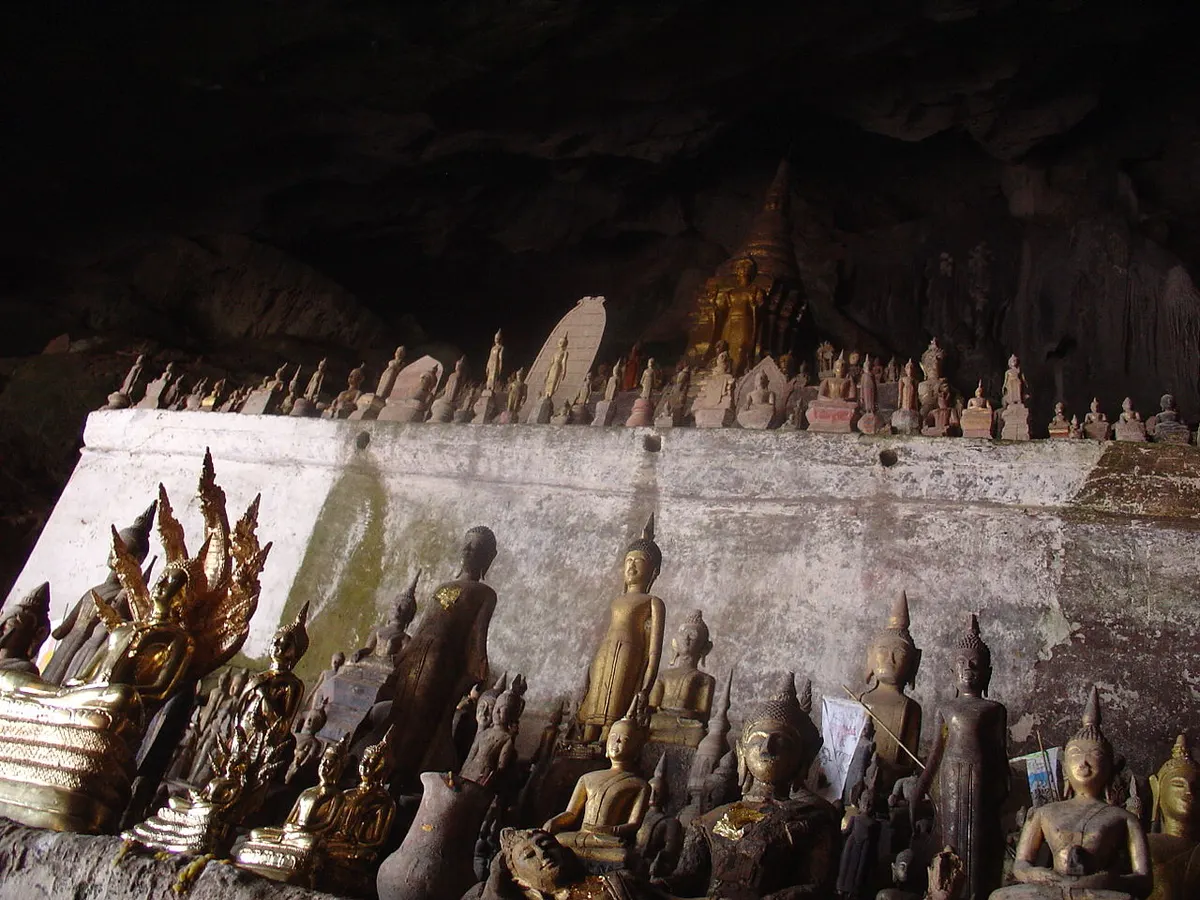 Thousands of gold Buddha statues inside the Pak Ou Caves visited on a Mekong waterfall tour from Luang Prabang, Laos