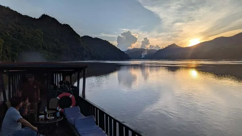 Sunset Mekong cruise after swimming at the Kuang Si waterfalls in Luang Prabang, Laos